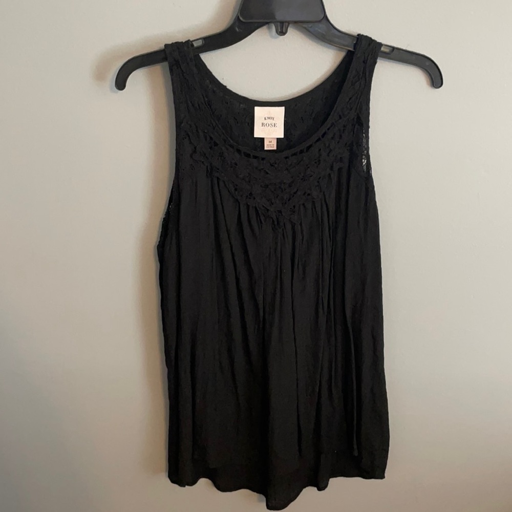 Black flowy tank top with a lacey top.
